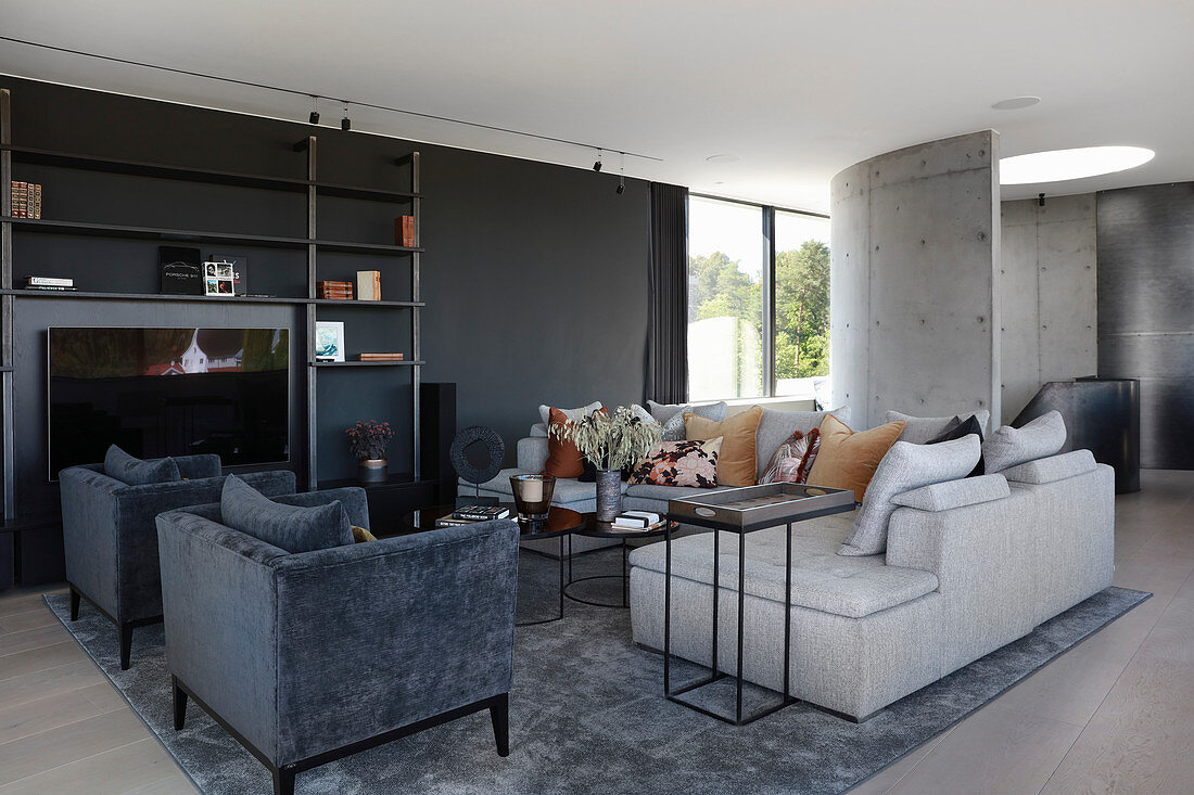 Velvet armchairs and sofa in elegant living room in shades of grey