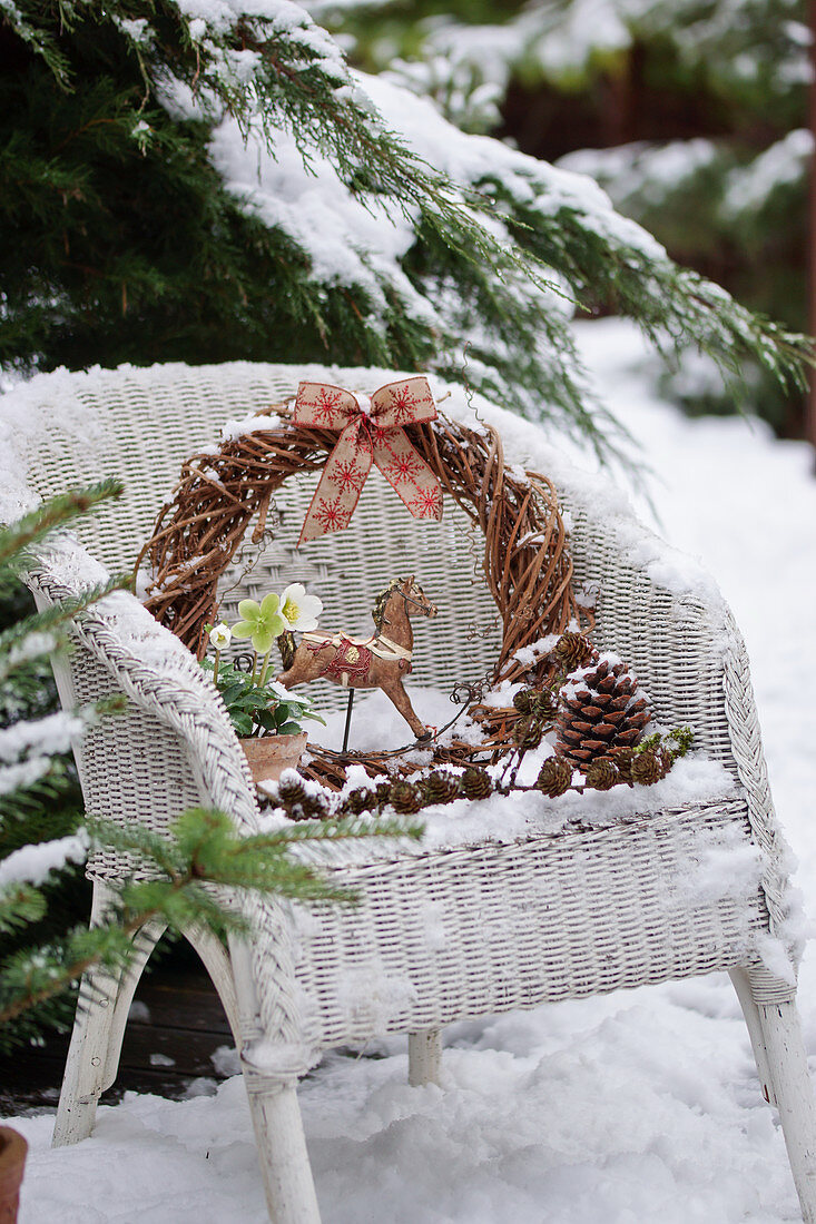 Small Christmas arrangement on wicker armchairs in the snow