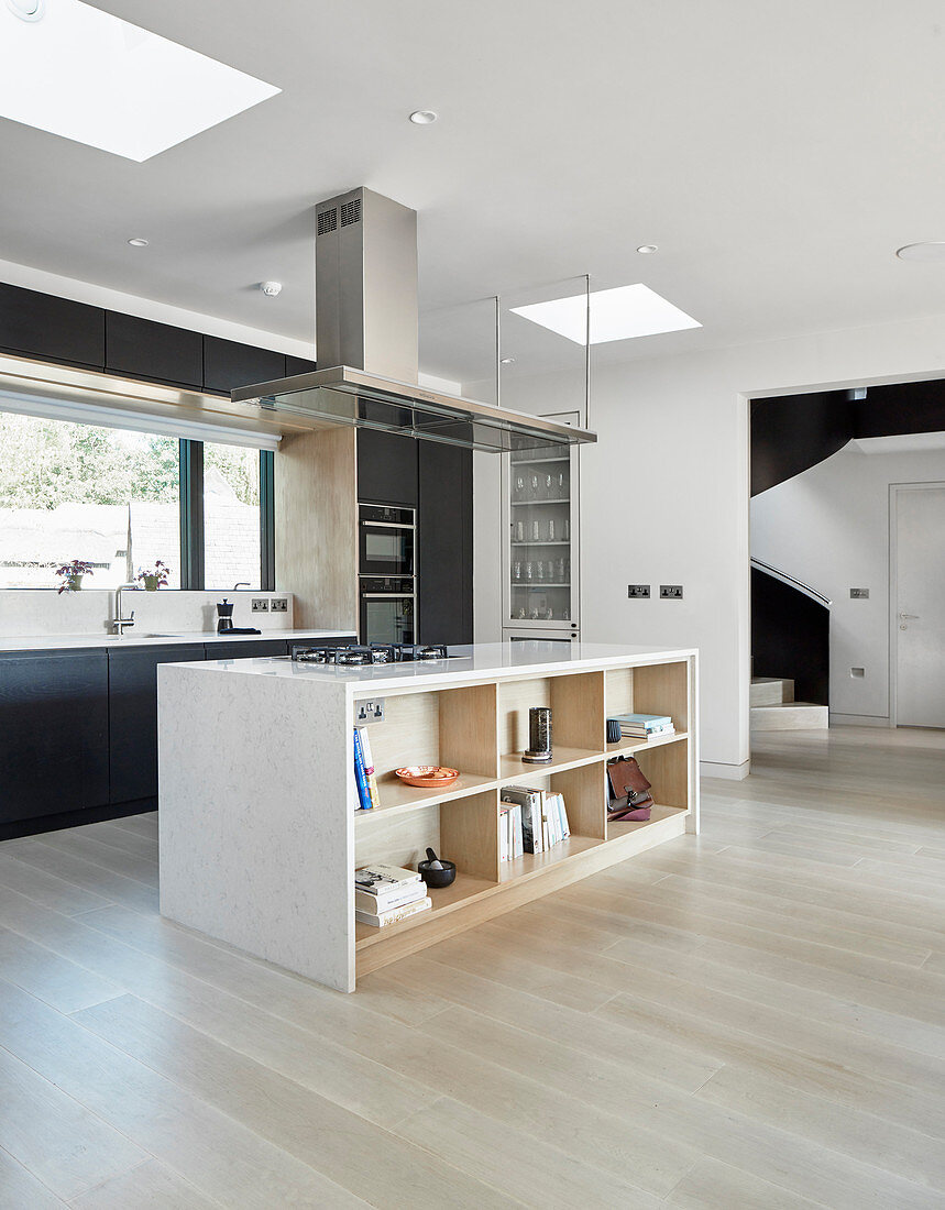 Island counter with shelves below in open-plan minimalist kitchen