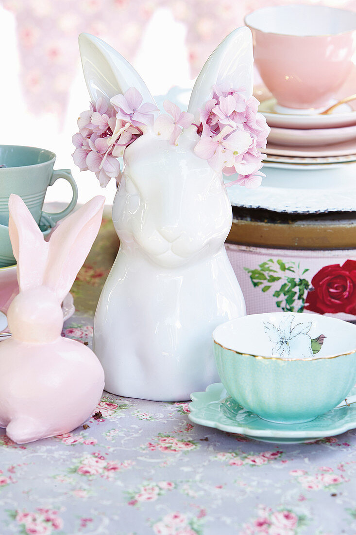 Easter bunny with flowers on table set in vintage style