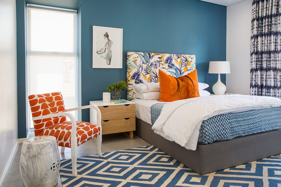 Blue and white bedroom with orange accents