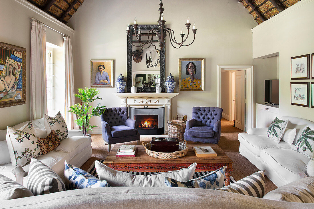 Sofa combination in living room with thatched gable ceiling in renovated farmhouse