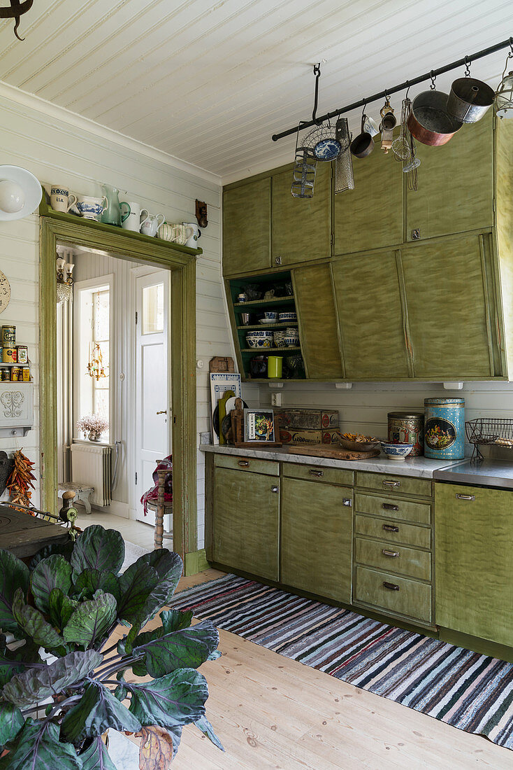 Old fitted kitchen with green, retro-style cabinets