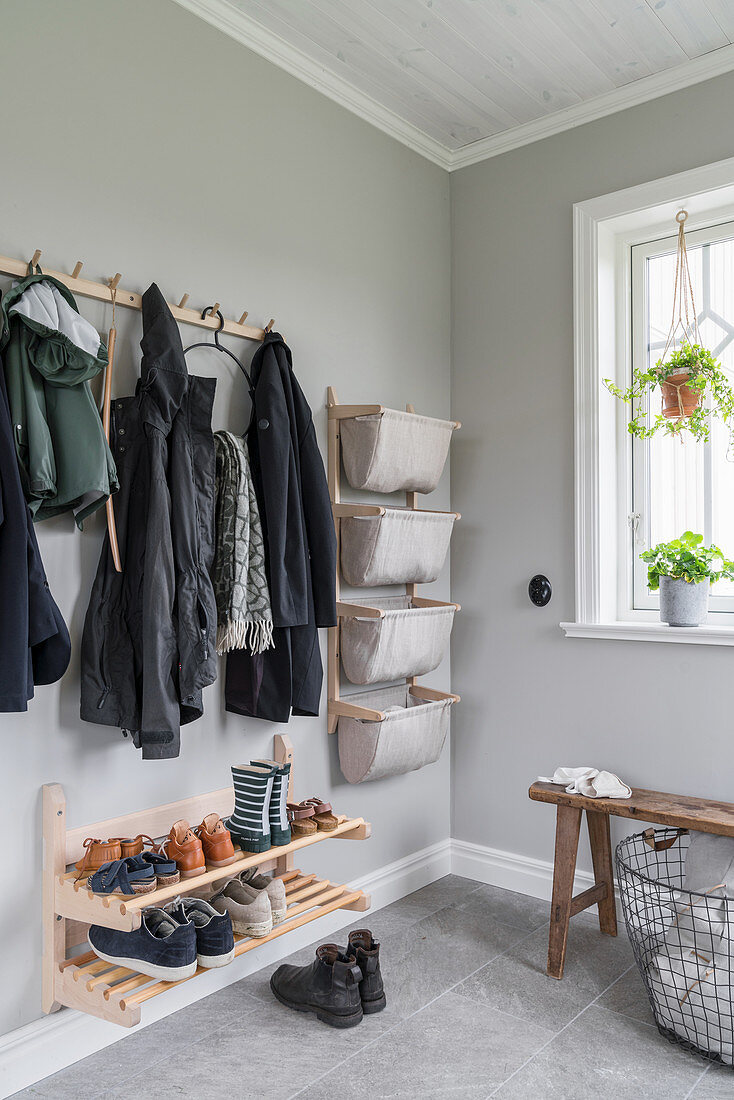 Open cloakroom in hallway with pale grey walls