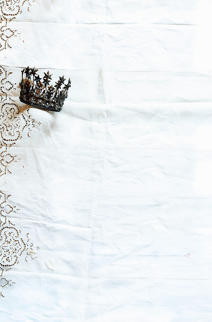 Crown on white broderie anglaise tablecloth