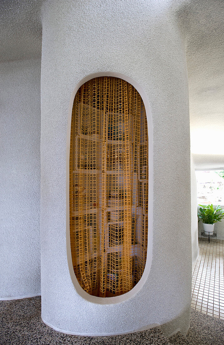 Kleine Vorratskammer mit Vorhang und organisch geformten Wänden