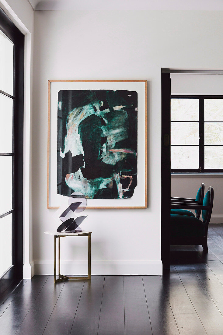 Modern art over side table with sculpture