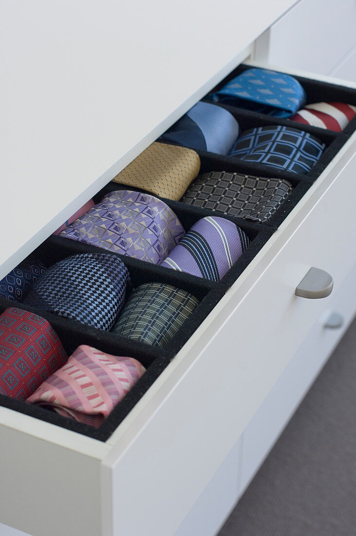 Various neckties in open drawer