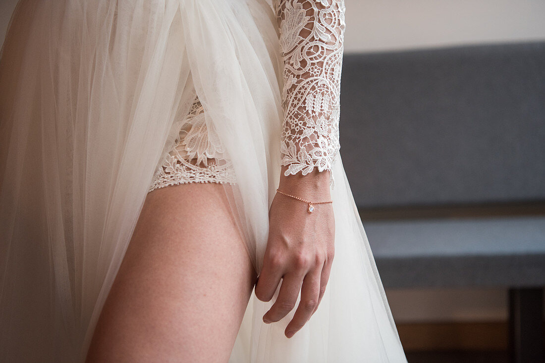 Bride wearing wedding gown with thigh-high slit