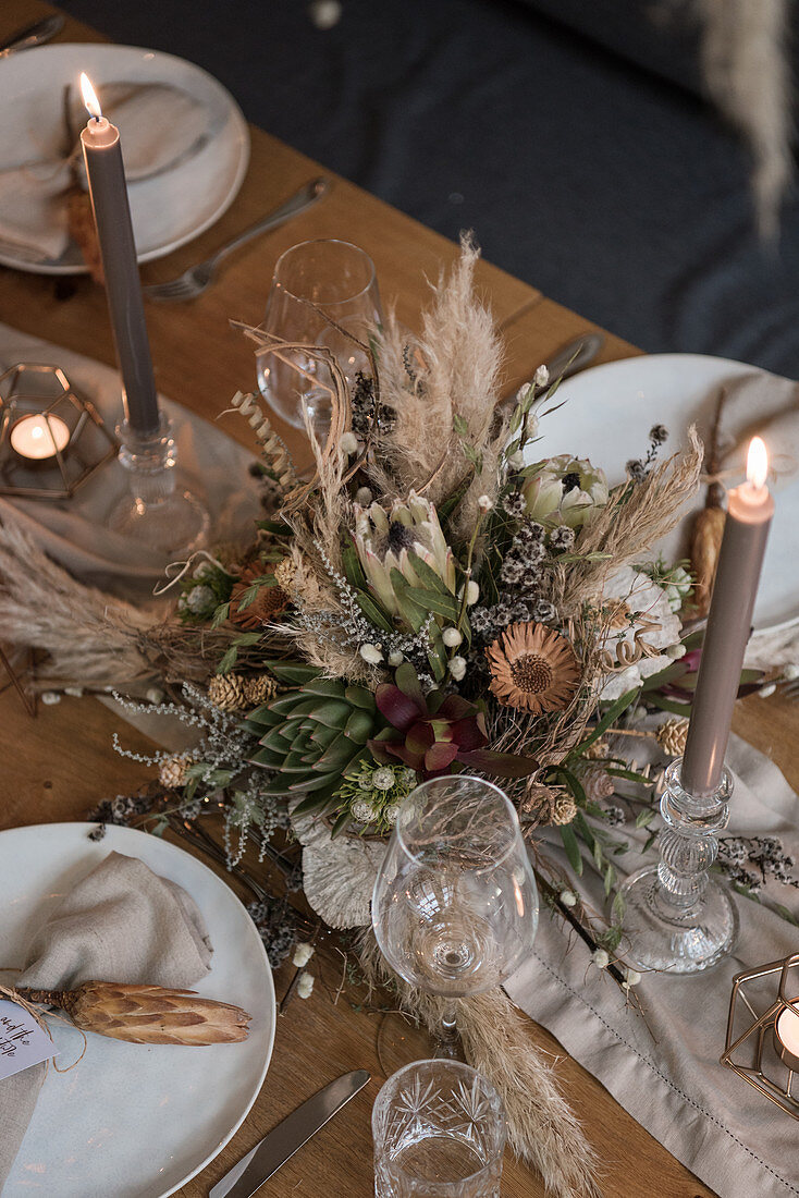 Arrangement of dried flowers on table set for wedding