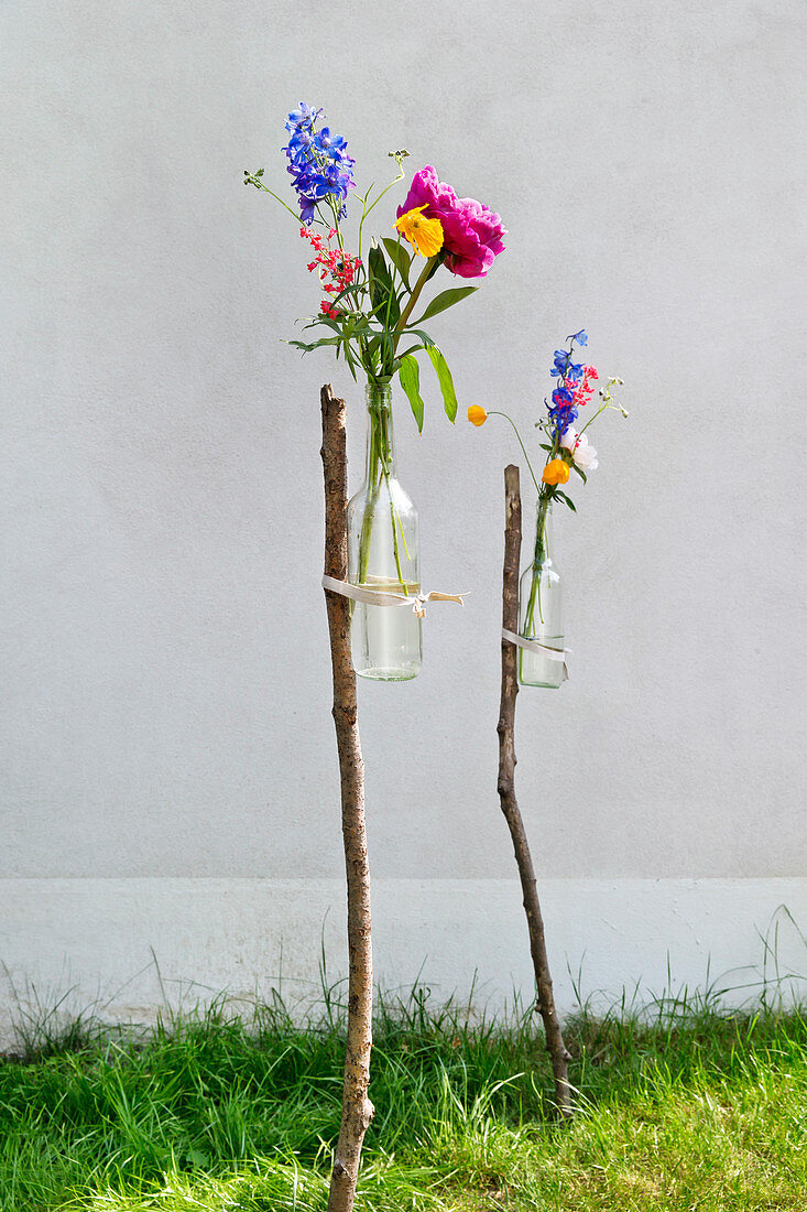 Flowers in DIY vases in garden