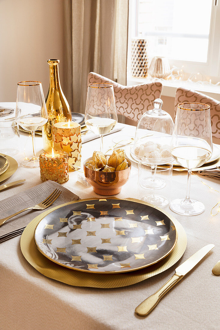 Table festively set in gold and white with portrait plates