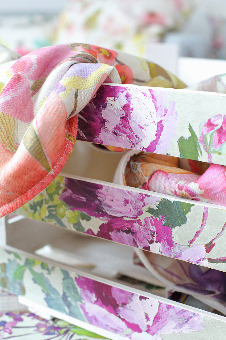 Wooden crate decorated with floral wallpaper remnants