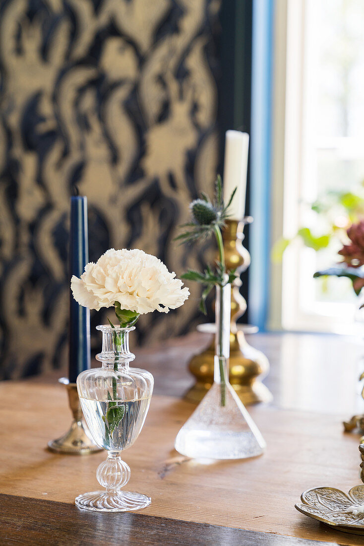 Glass vases and candlesticks on dining table
