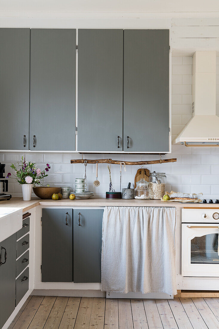 Kitchen with grey cupboard fronts in country-house style
