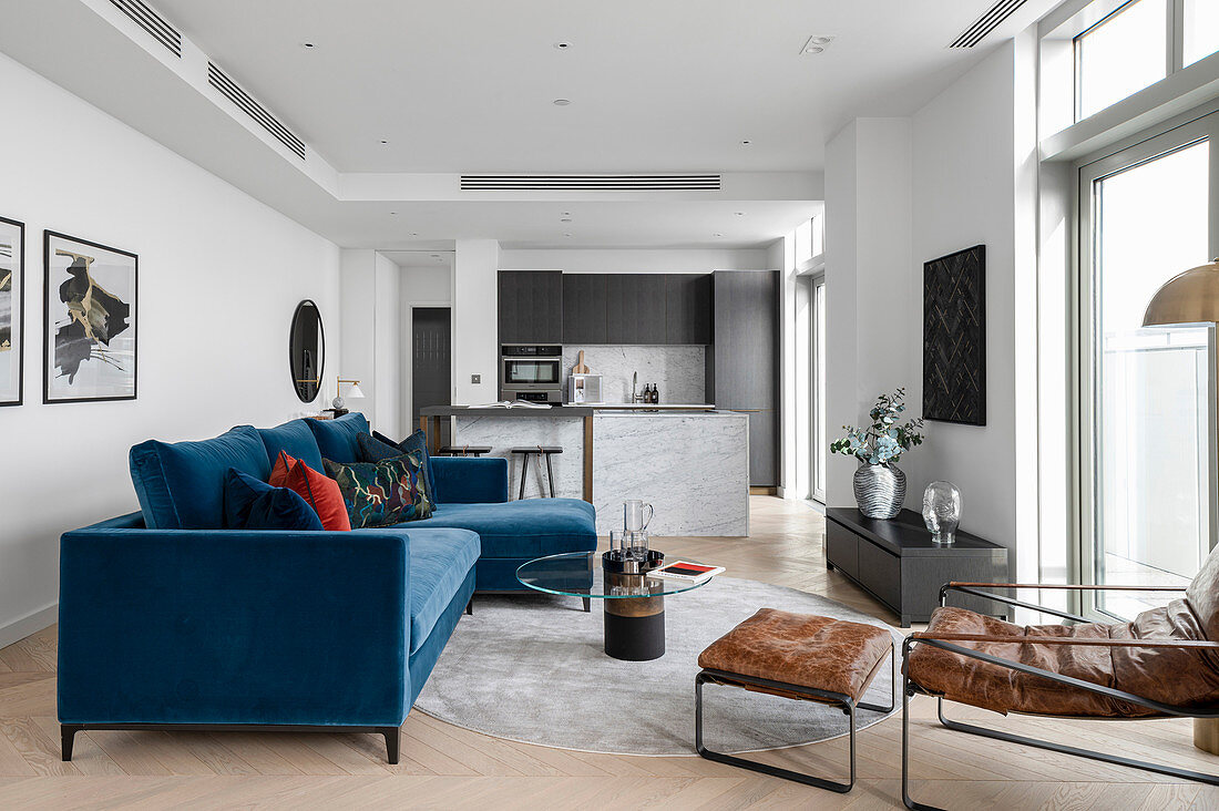 Blaues Samtsofa im modernen offenen Wohnraum im Designerstil
