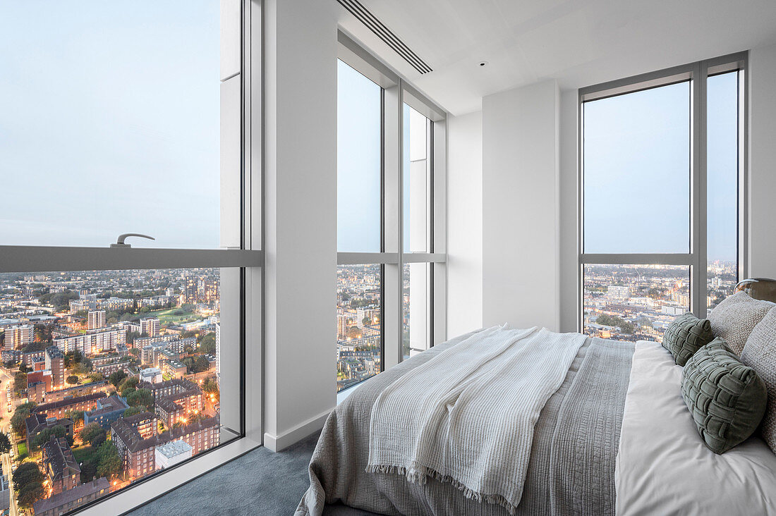 Bedroom with a view of the city in a modern high-rise