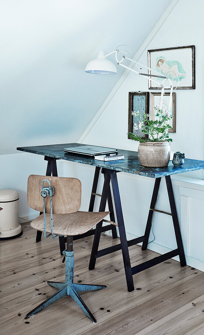 Small workspace with vintage chair in the attic