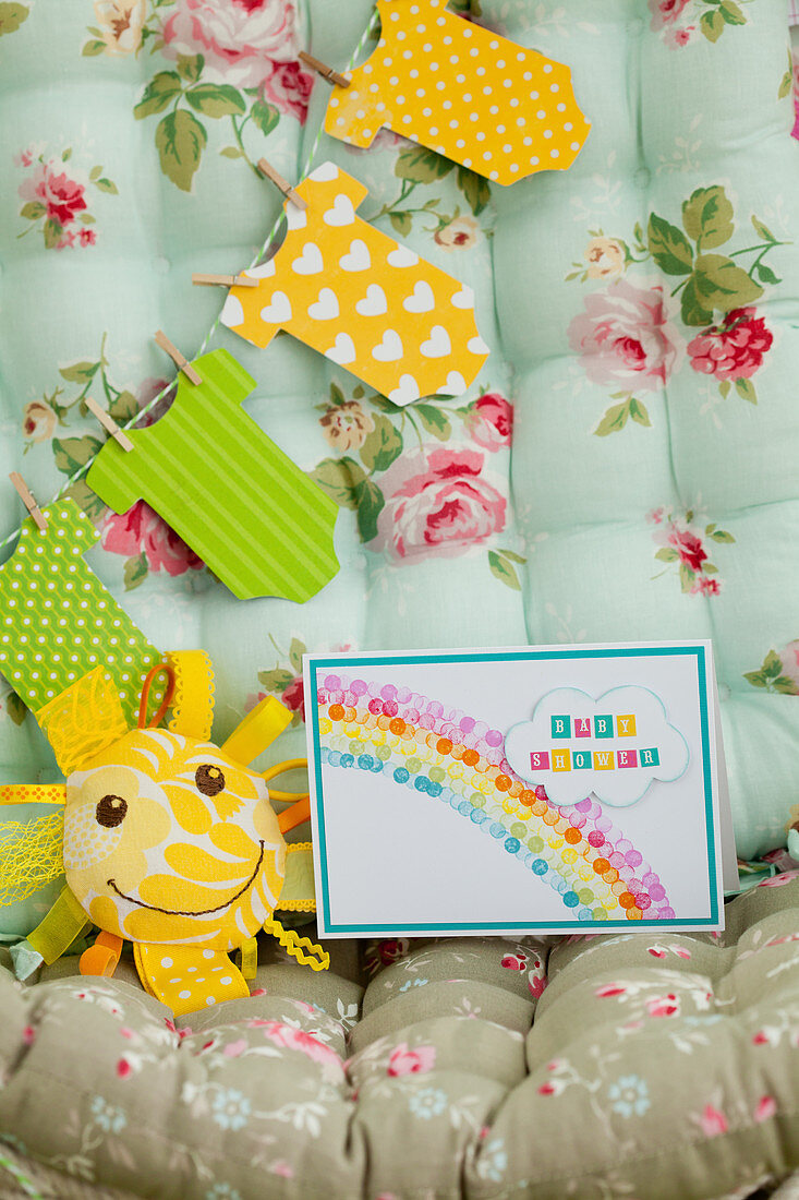 Invitation with rainbow and paper garland onesies