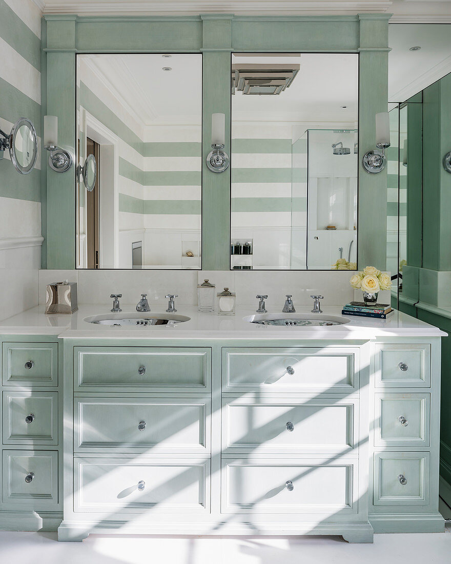 Washstand with drawers in mint-green bathroom