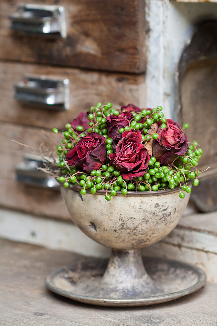 Arrangement of dried roses and unripe berries