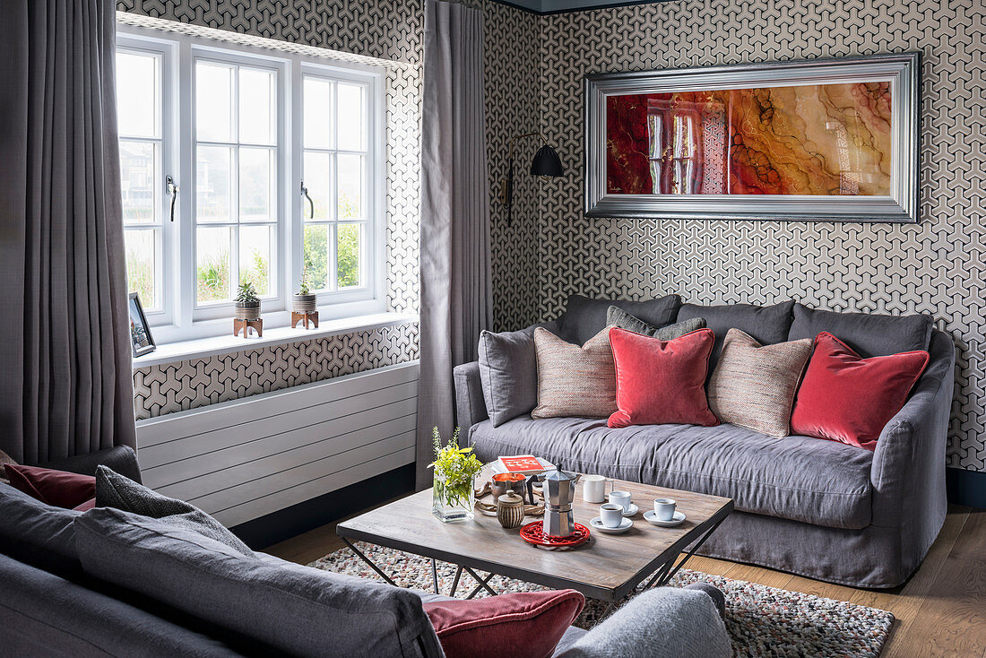 Gegenüberstehende Sofas im Wohnzimmer mit grafischer Tapete