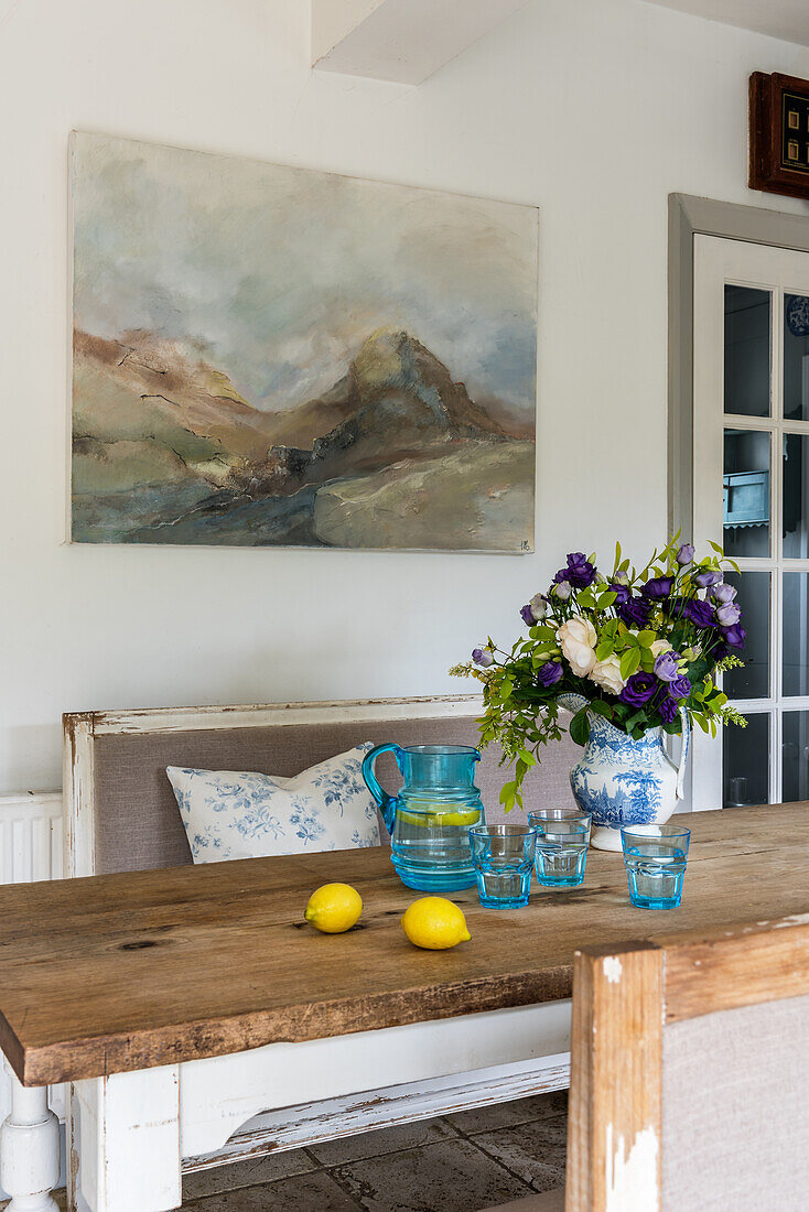 Atmospheric paintings above a Gustavian bench in the kitchen