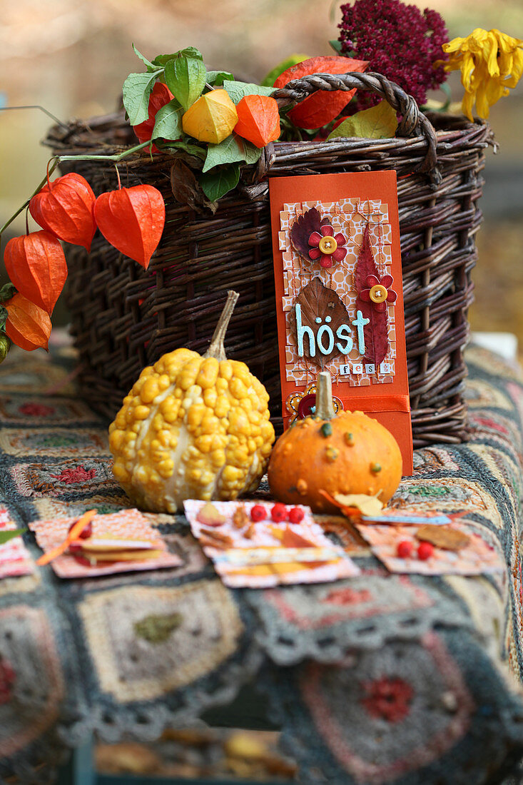 Autumn decoration idea with cards, decorative pumpkins, lantern flowers, and autumn leaves