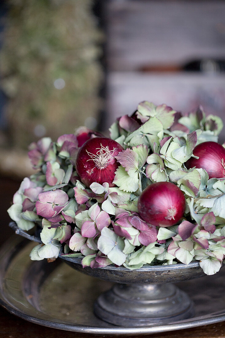 Red onions and hydrangea blossoms in a pewter bowl
