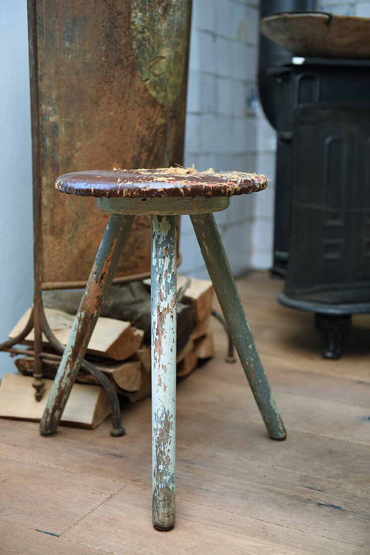 Old, battered stool with peeling paint