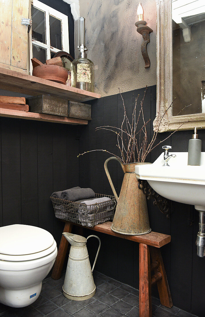 Small bathroom with panelled walls and vintage-style accessories