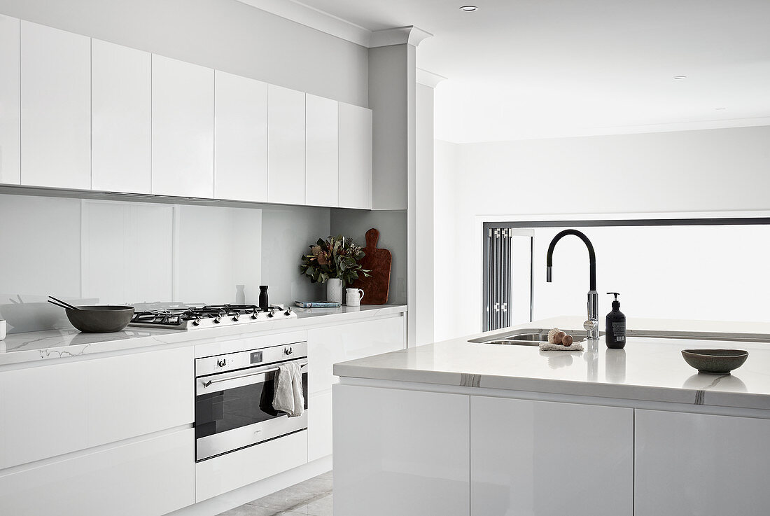 White, modern, minimalist, kitchen with high-gloss cabinets