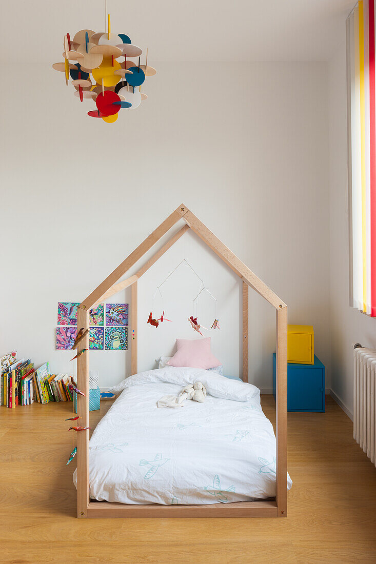 Child's bed under house-shaped frame