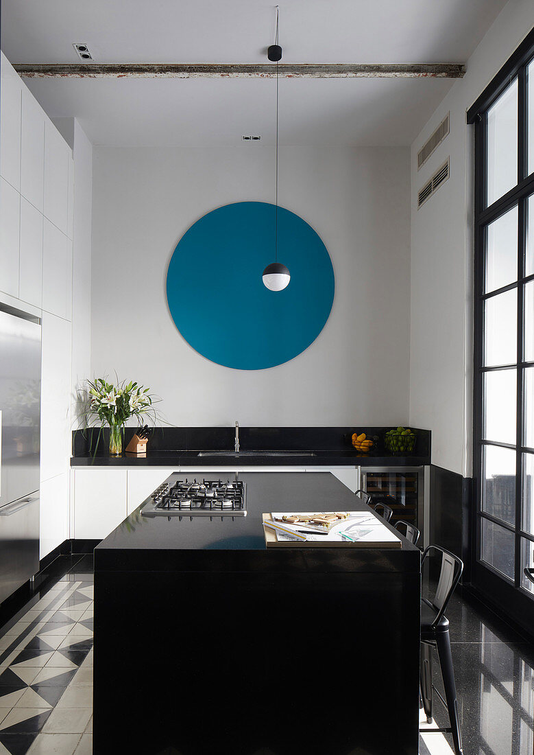 Blue circle on wall of modern kitchen with island counter