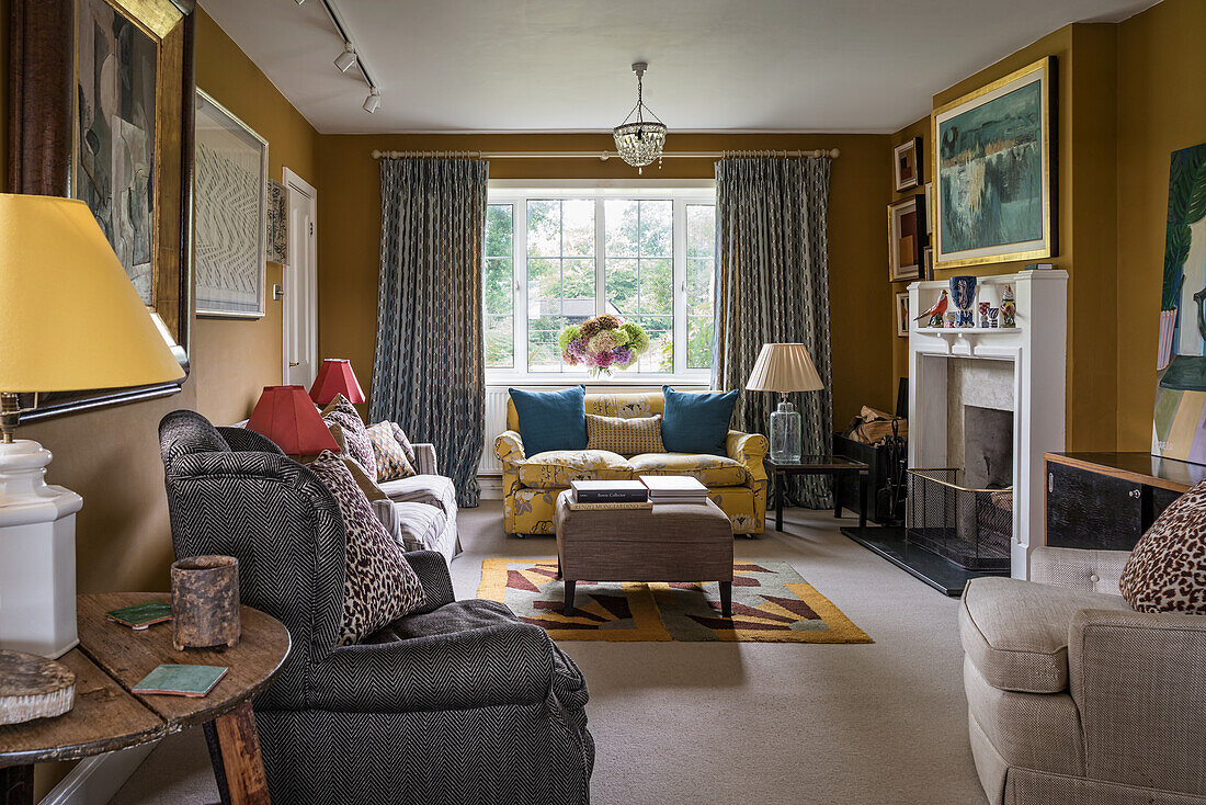 Various seating in sitting room with mustard-yellow walls