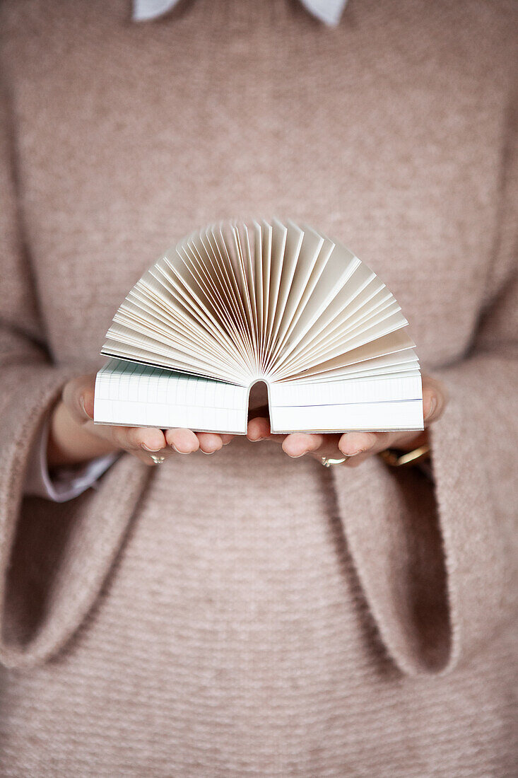 Woman's hands holding an open book