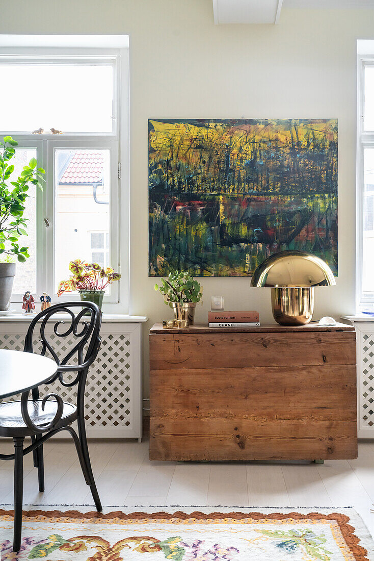 Rustic wooden console, painting above in dining area