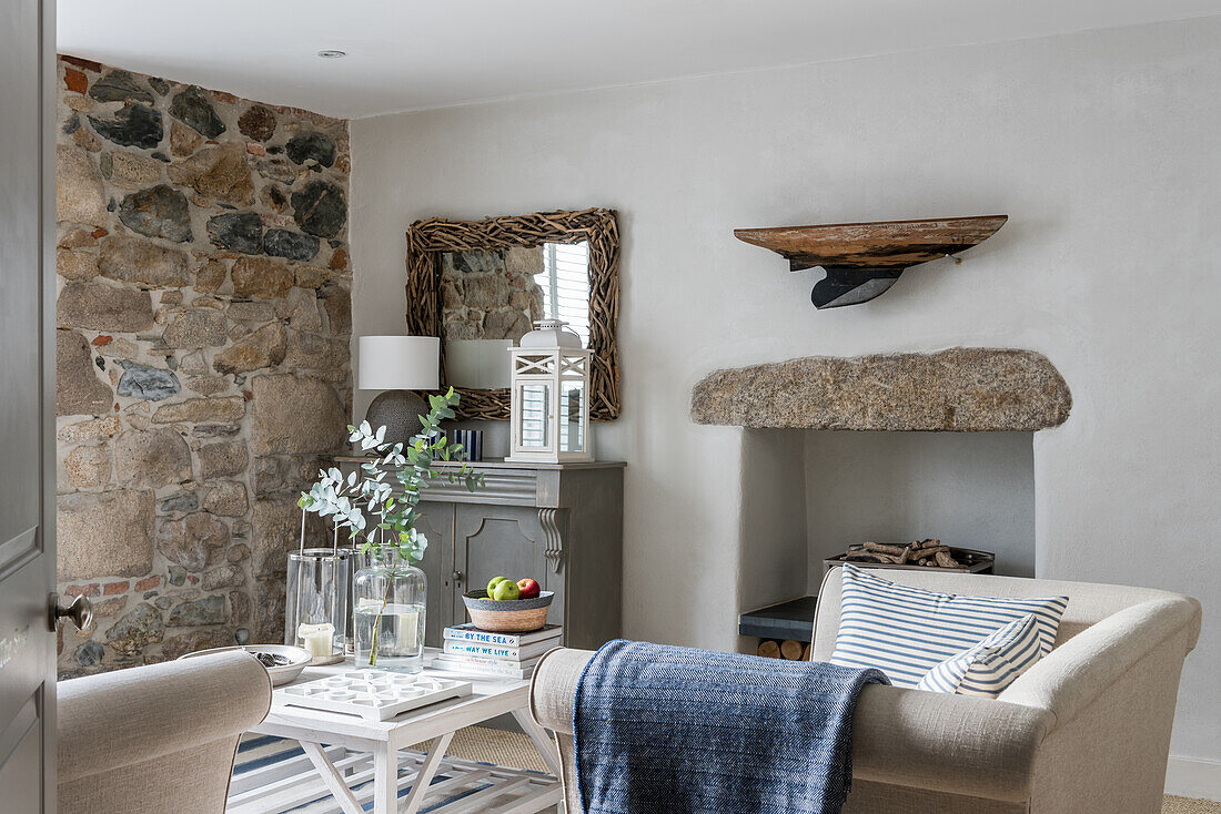 Snug sitting room with exposed stone wall, small Chester sofa and herringbone blanket
