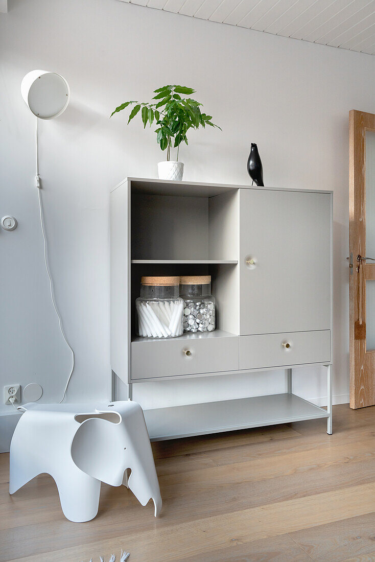 Modern children's chair in elephant shape in front of a hutch