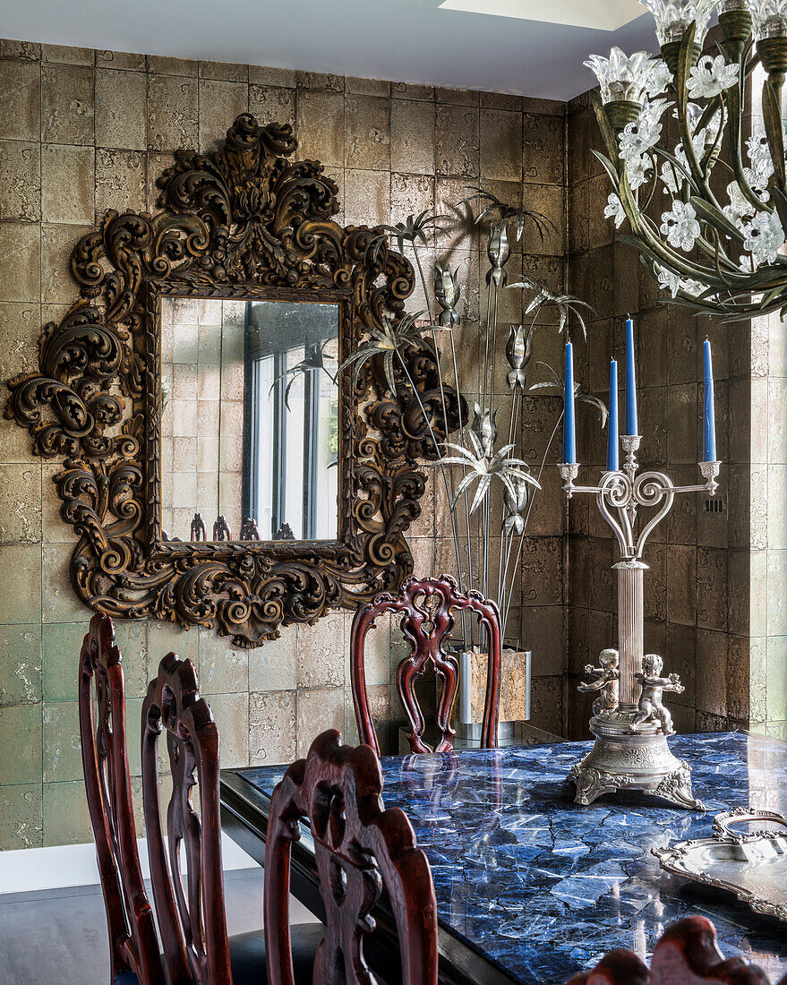 Opulent baroque mirror on tiled wall in dining room