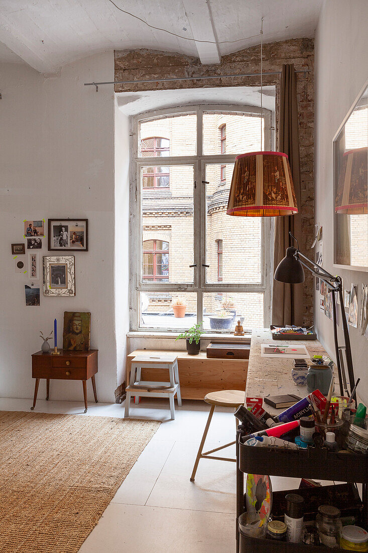 Studio in an old building in industrial style with simple, vintage-style furnishings