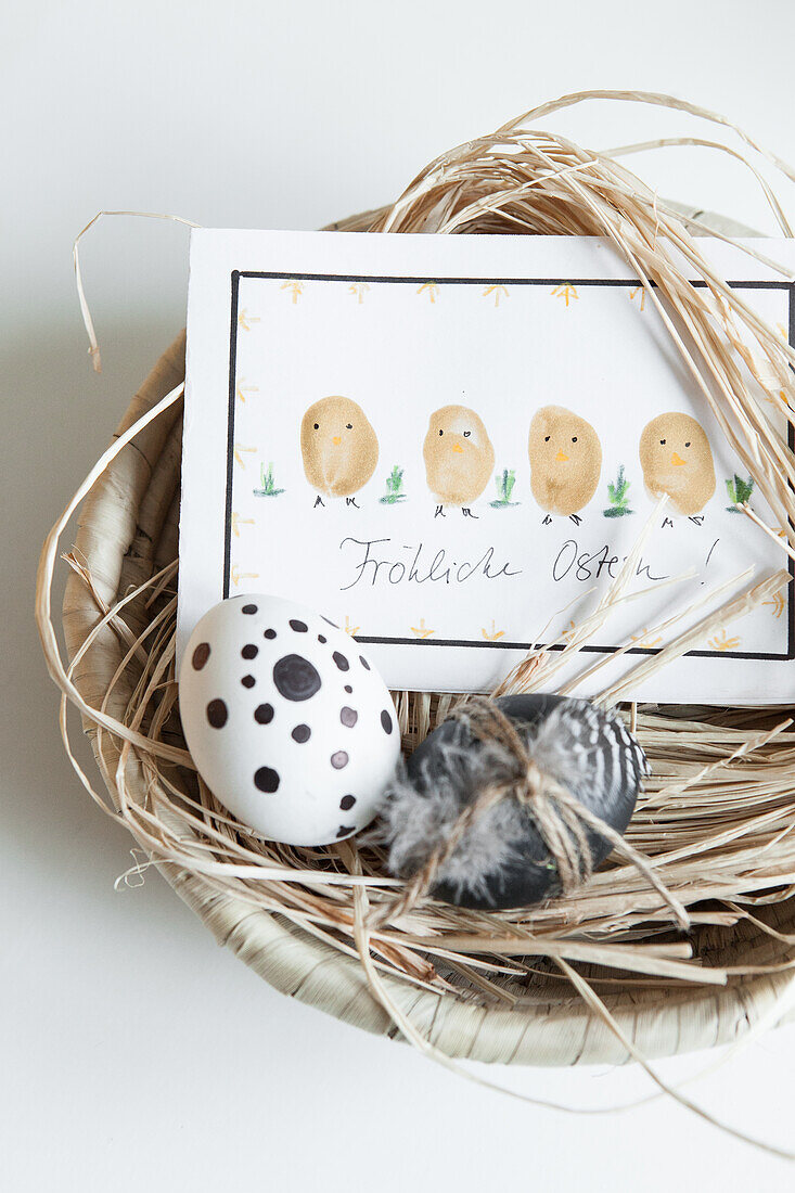 Easter nest with painted eggs and greeting card