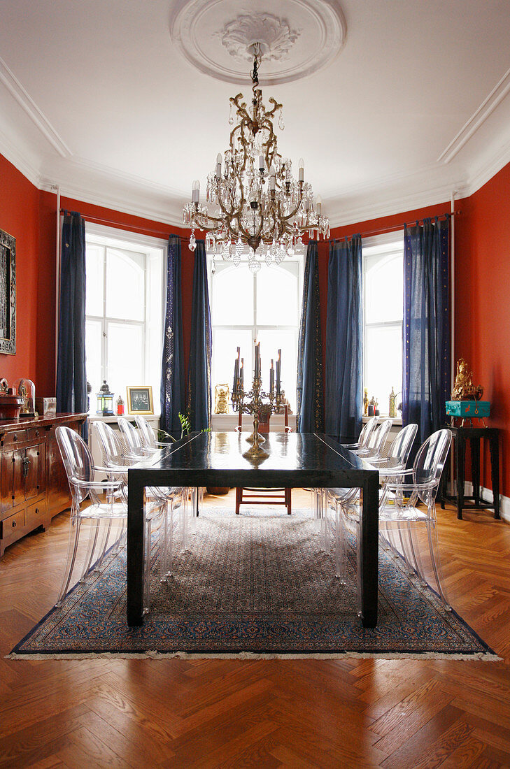 Dining room with red walls and designer chairs