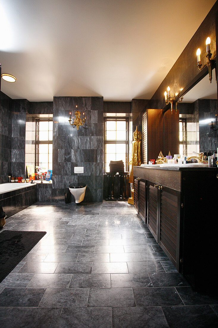 Elegant bathroom with dark marble tiles