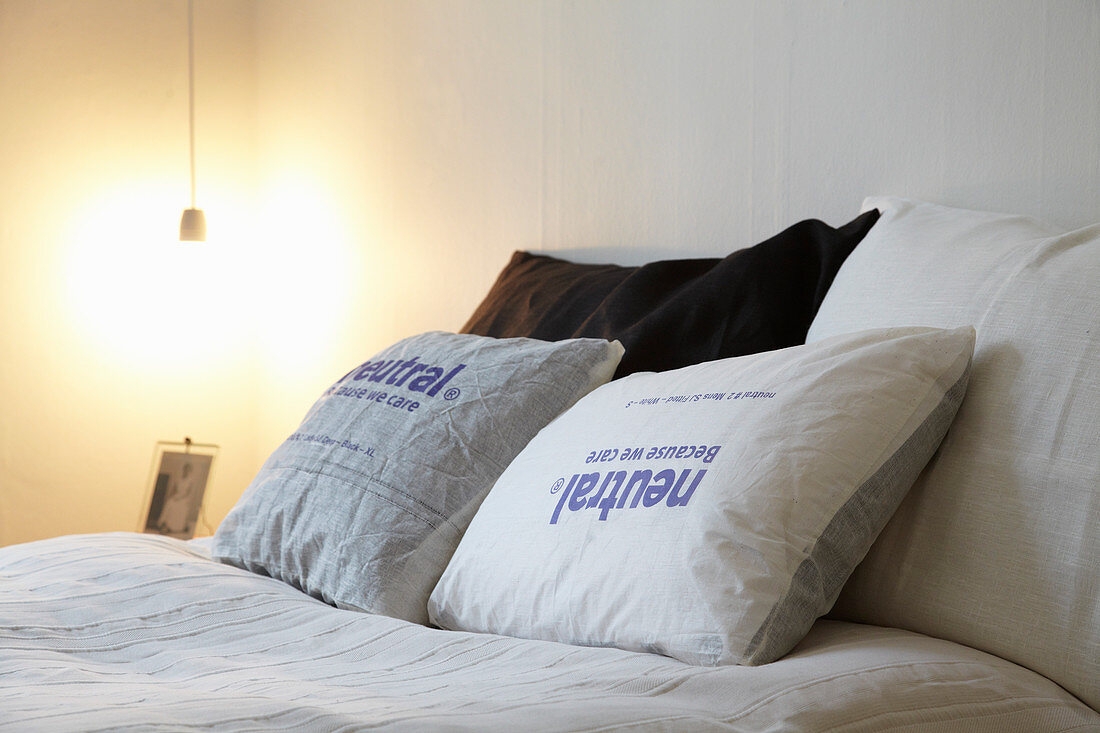 Cushions with printed covers on double bed