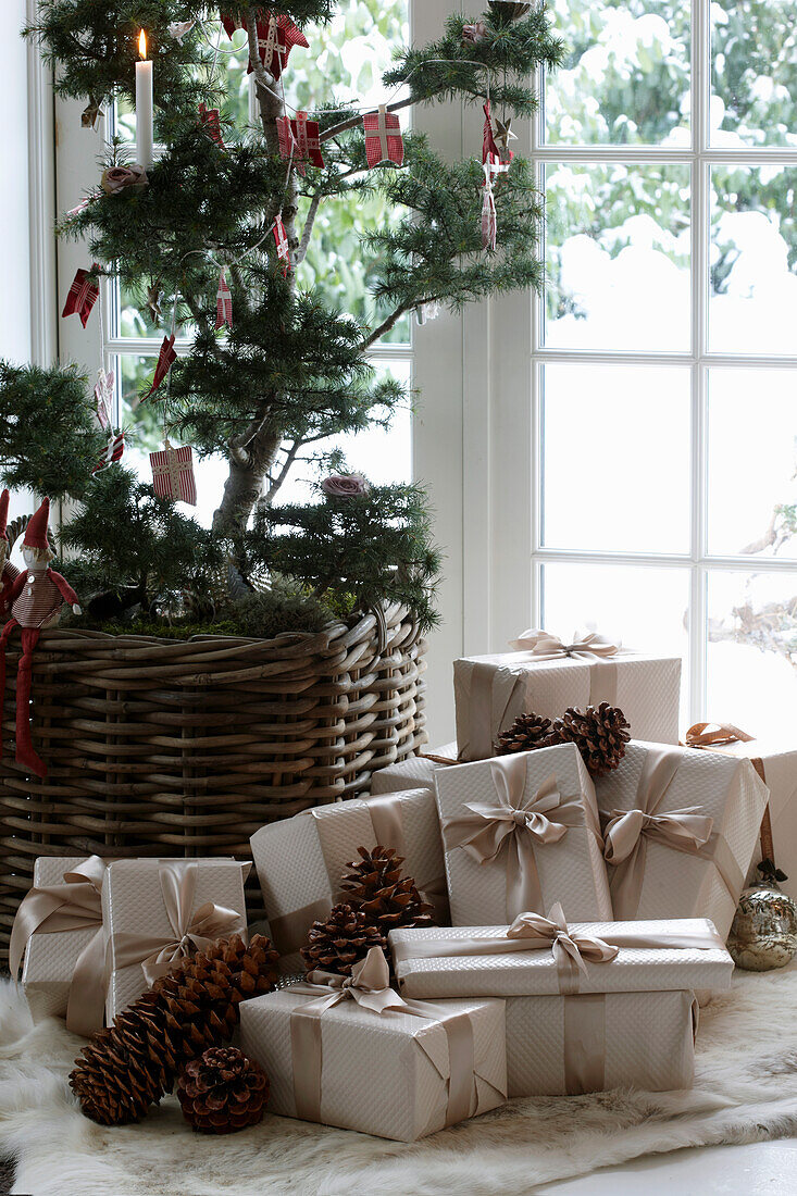 Decorated tree and Christmas presents in front of a French window