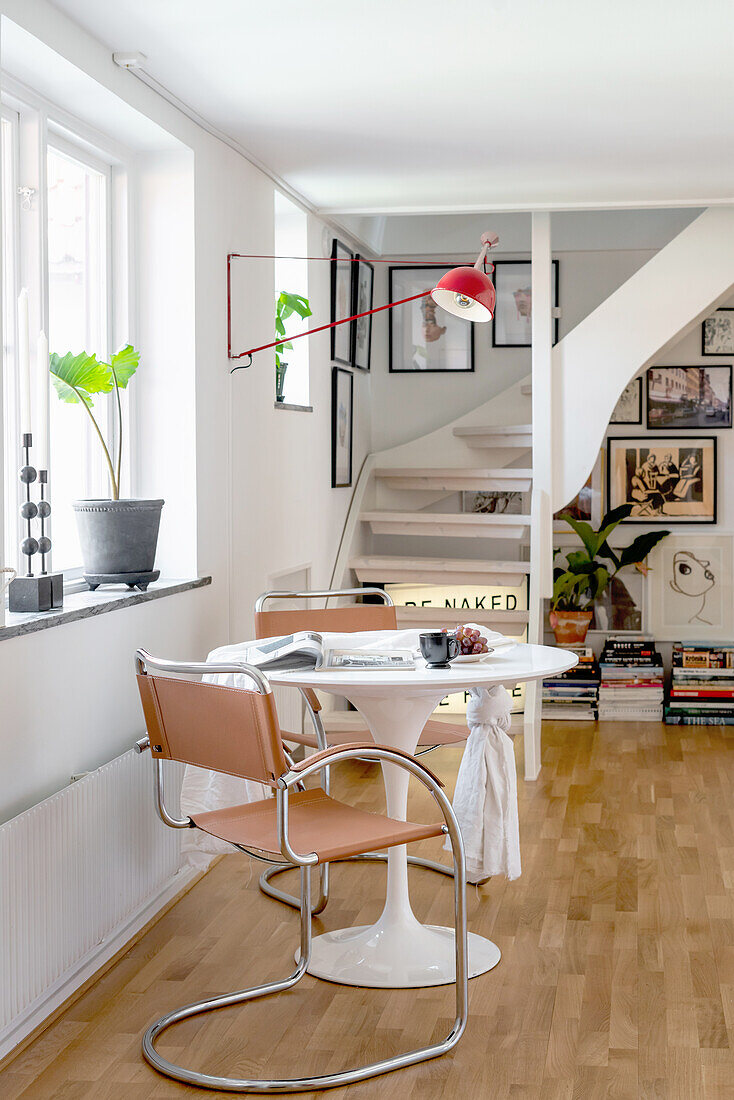 Classic table and cantilever chairs in front of staircase