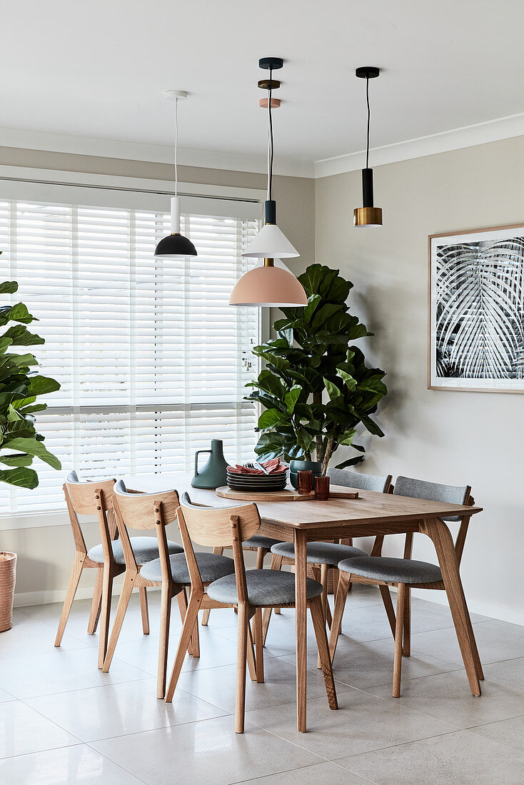 Pendant lamps in dining area and houseplants next to window