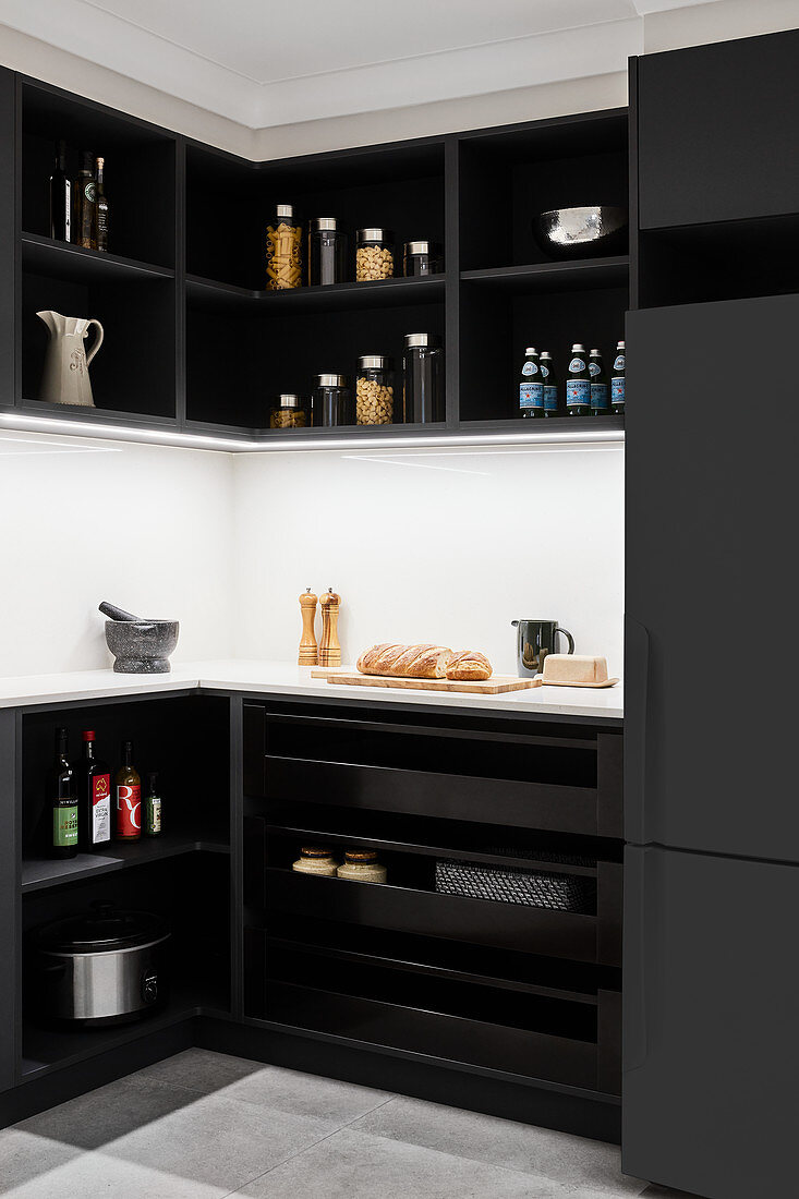 Black kitchen cabinets with white splashback