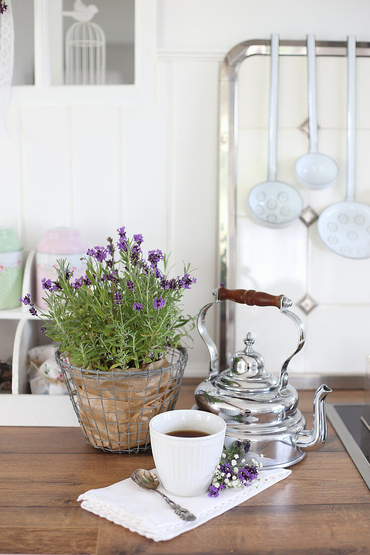 Lavender in a wire basket and kettle in a nostalgic kitchen